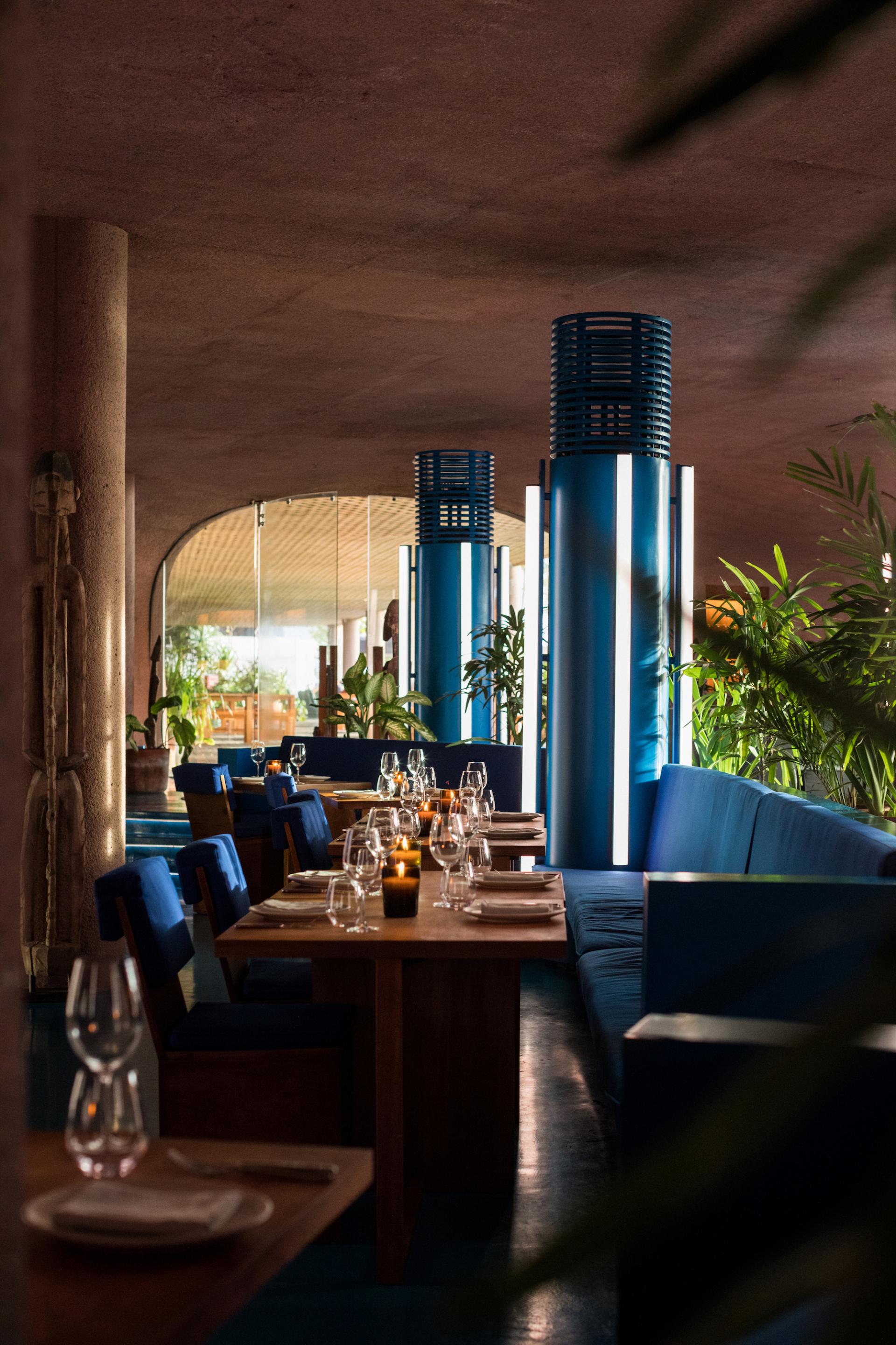Futuristic dining space at Dome, Desa Potato Head, featuring cobalt blue accents and earthy design elements.
