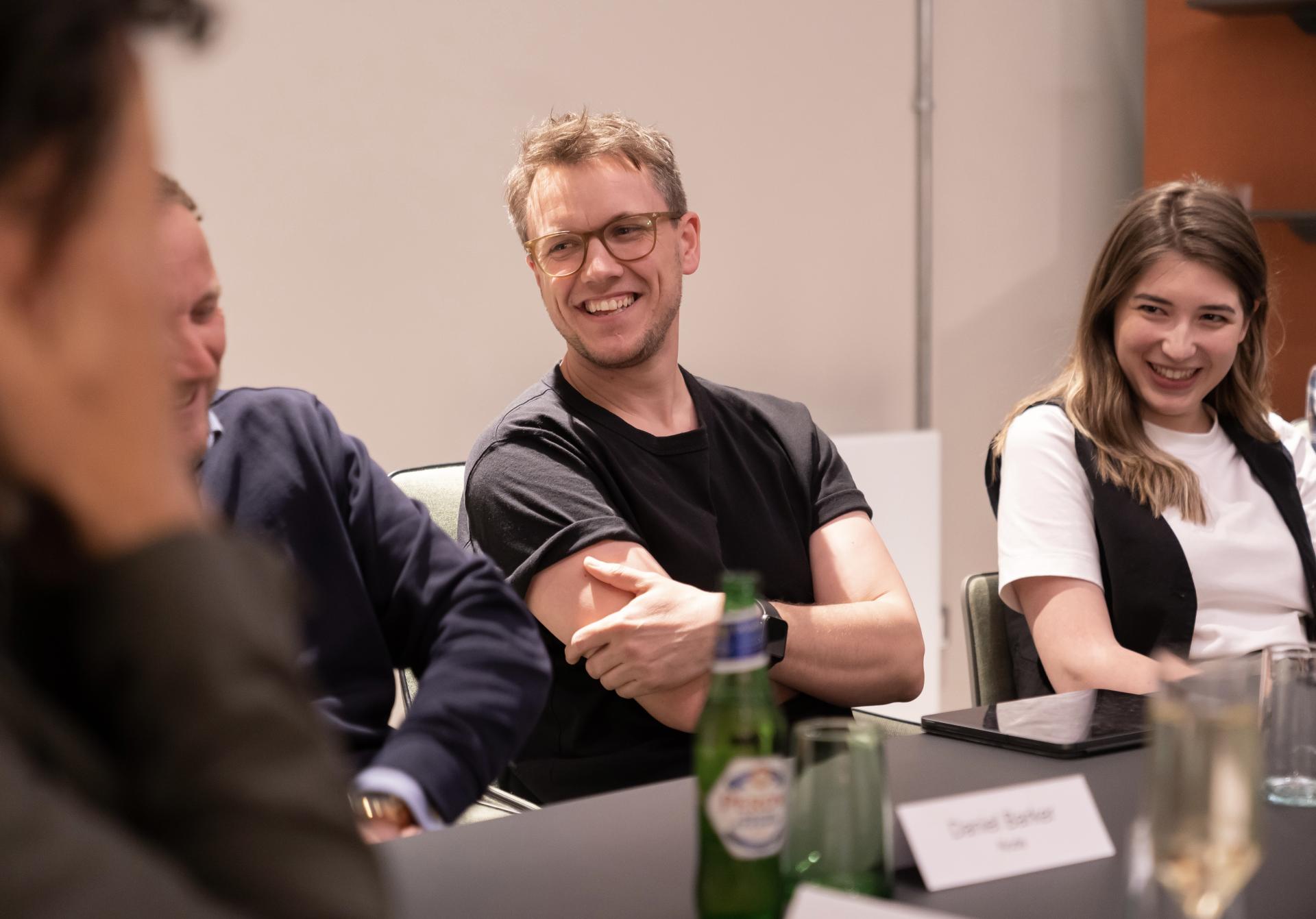Participants engaging in conversation at a technology seminar, highlighting collaboration in a modern workplace environment.