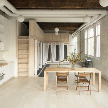Modern loft space designed by Corey Kingston in Seattle, featuring minimalist decor, light wood accents, and ample natural light.