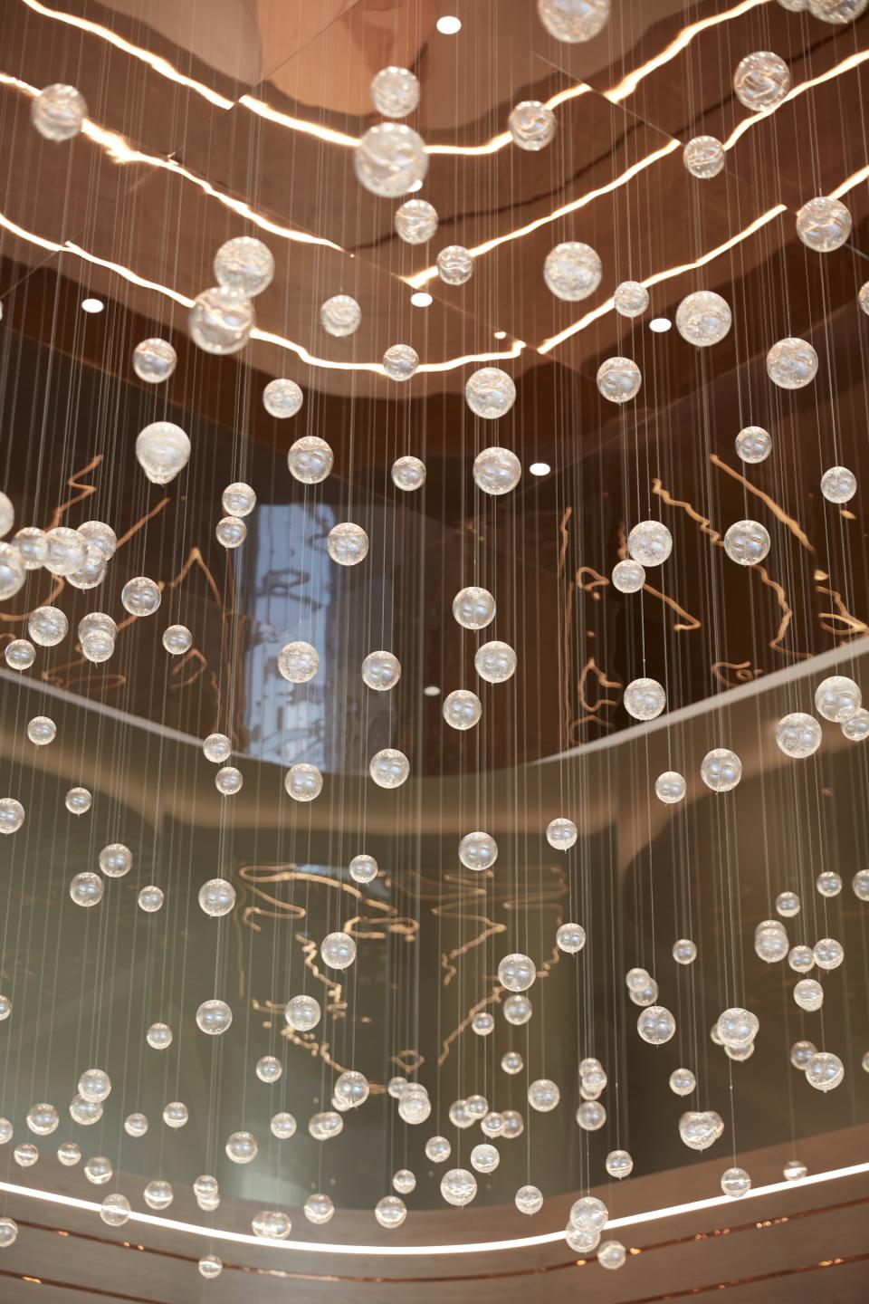 Contemporary lighting installation featuring suspended crystal spheres at Dubai Internet City's multi-purpose management offices.