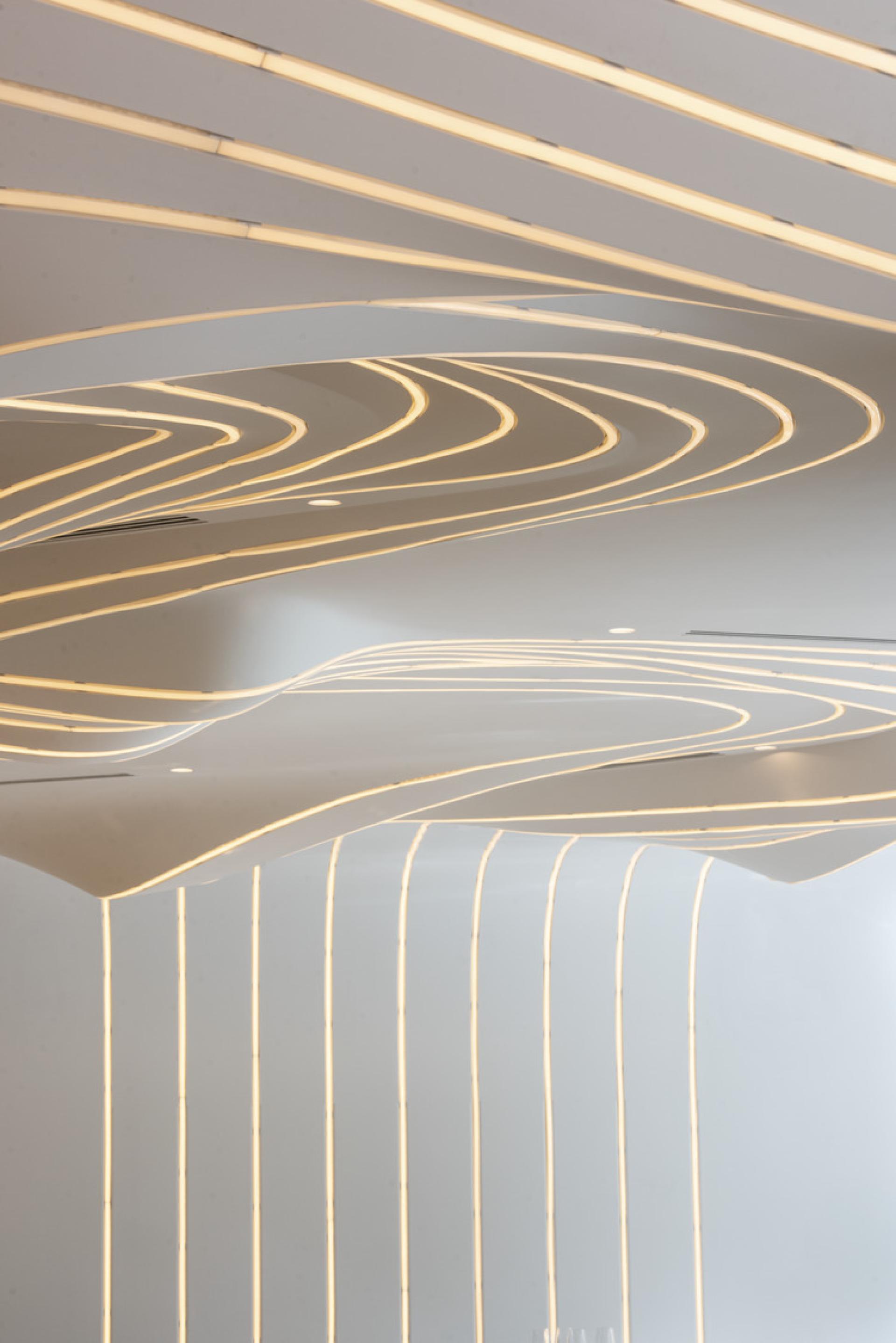 Innovative ceiling design with flowing lines and ambient lighting at VELA restaurant, inspired by star constellations.