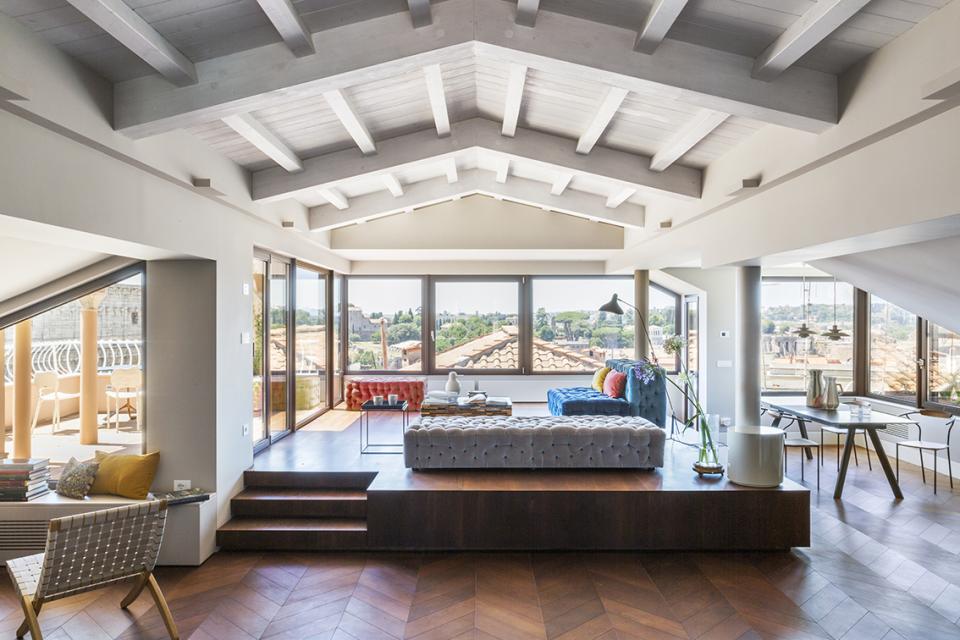 Luxurious artist's loft designed by Alvisi Kirimoto, featuring modern decor and stunning views of Rome's skyline.