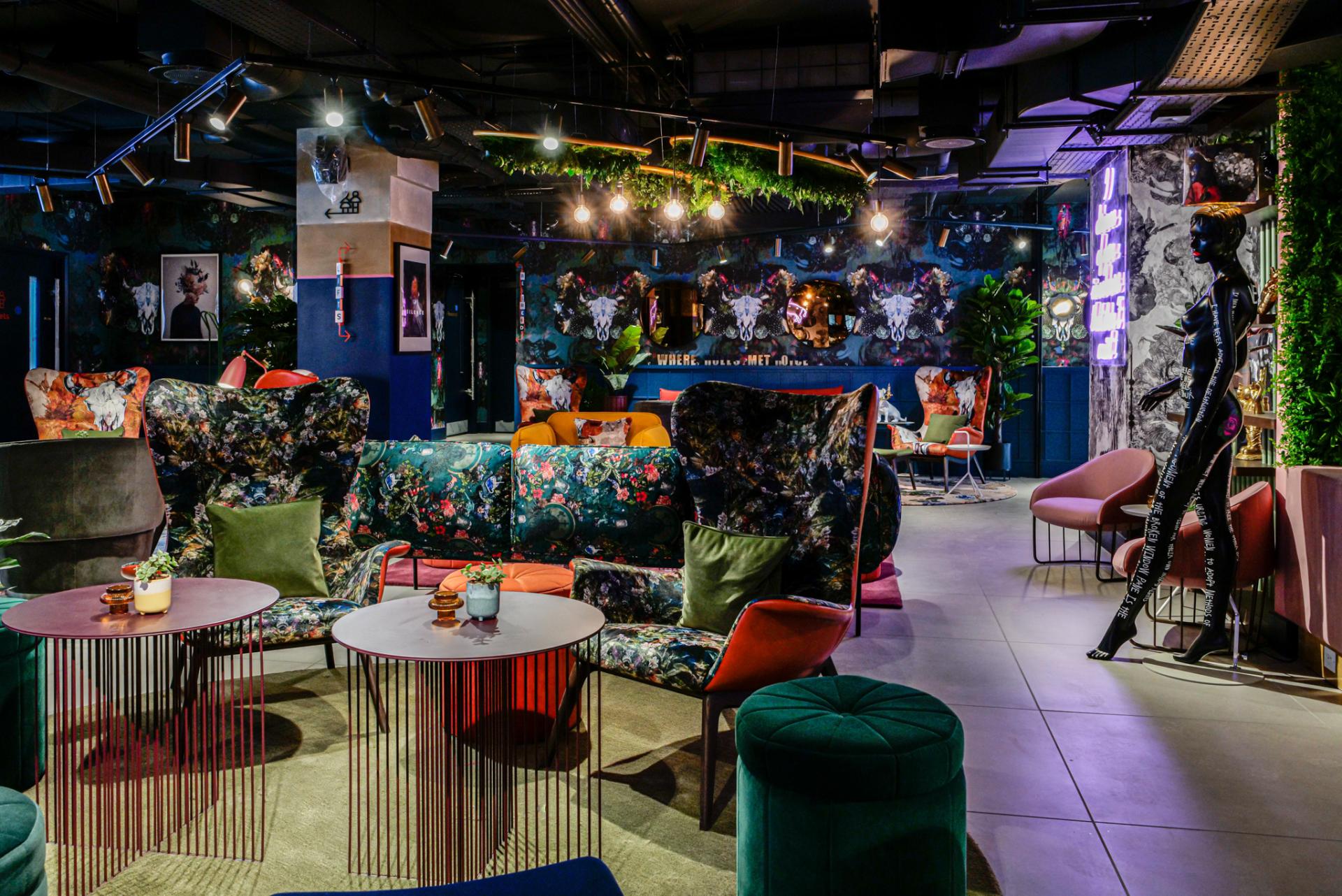 Vibrant lounge area at Qbic hotel featuring bold floral-patterned furnishings and artistic decor by BOBO1325.