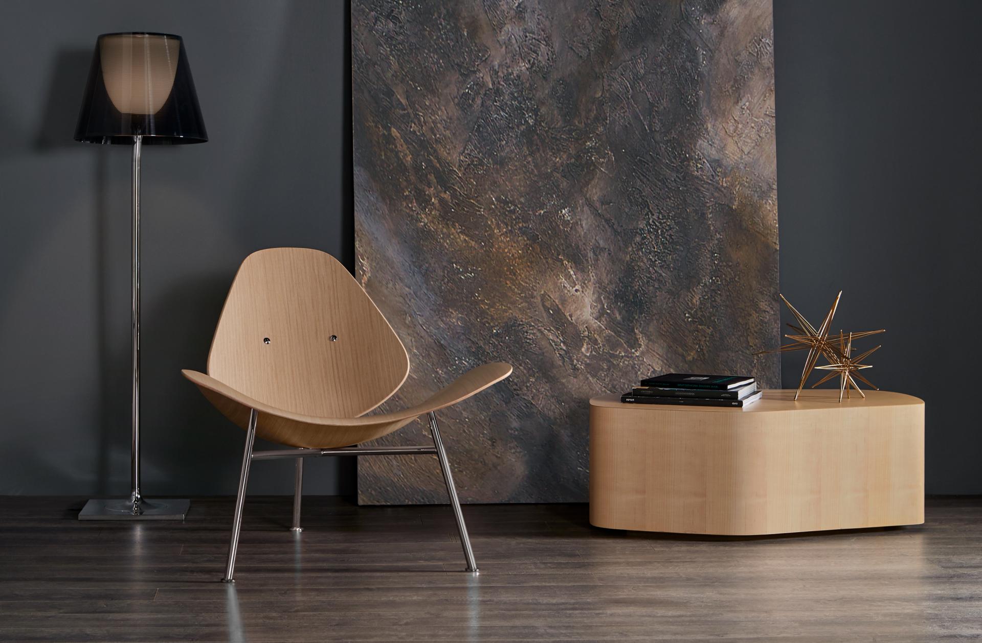 Pedersen lounge chair by Thomas Pedersen in a modern interior setting with a floor lamp and decorative table.