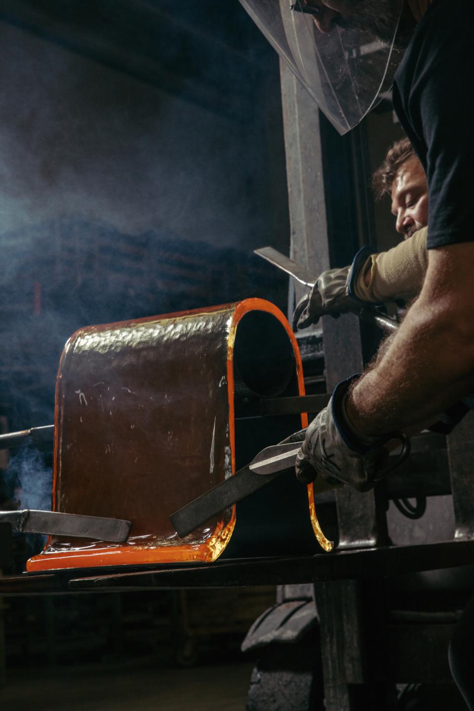 Artisans shaping cast glass for Melt collection by WonderGlass and nendo, showcasing innovative furniture design.