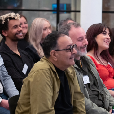 Diverse attendees engaged in discussion during the Material Source Studio event on hospitality branding and experience.