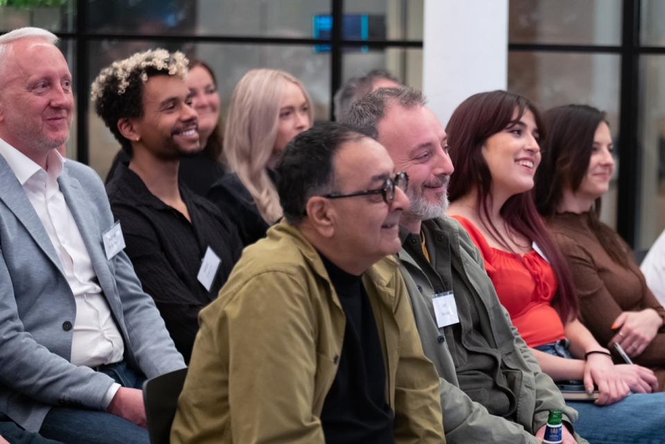 Diverse attendees engaged in discussion during the Material Source Studio event on hospitality branding and experience.