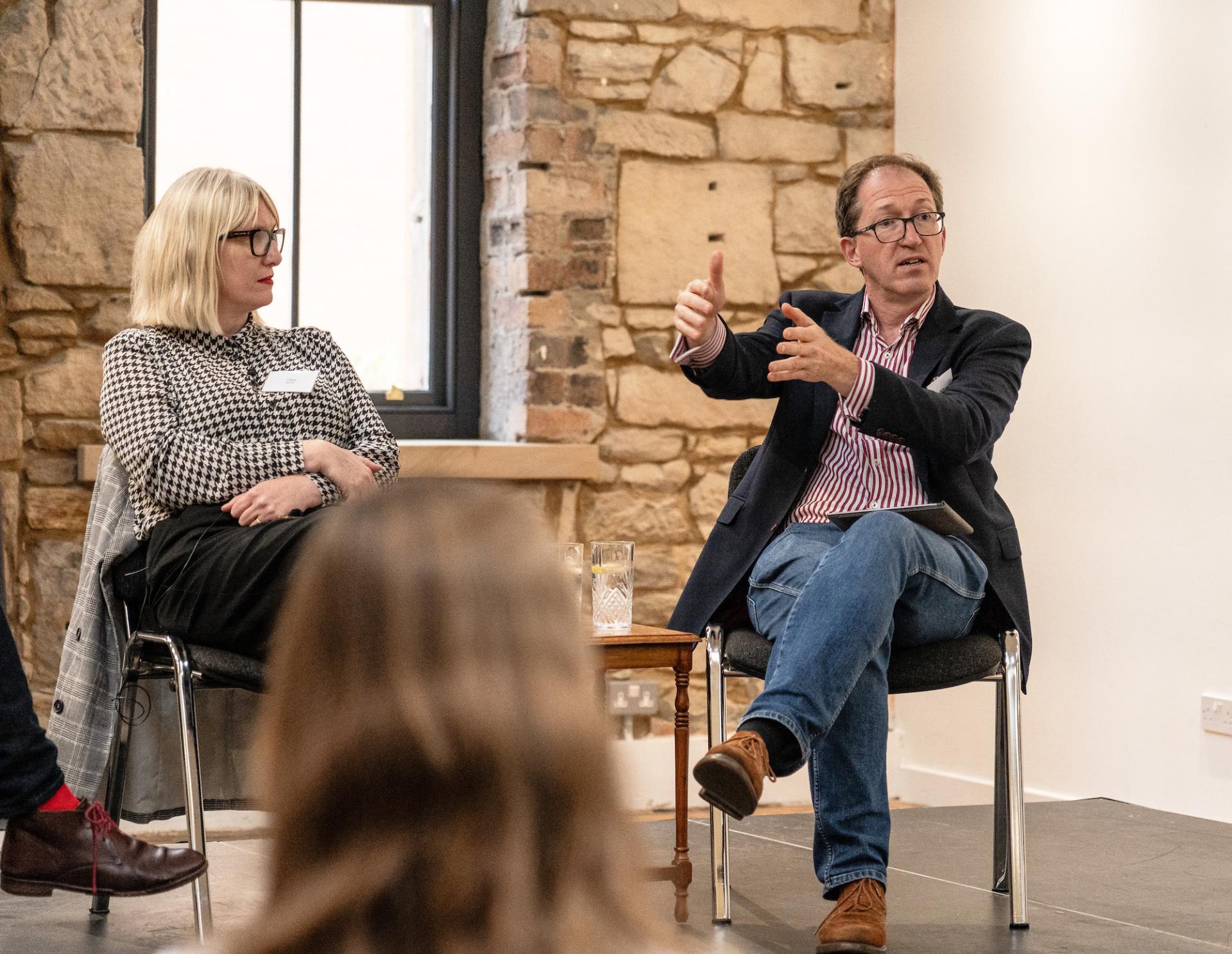 Panel discussion at the Glasgow Property Outlook seminar featuring speakers discussing real estate trends and future prospects.