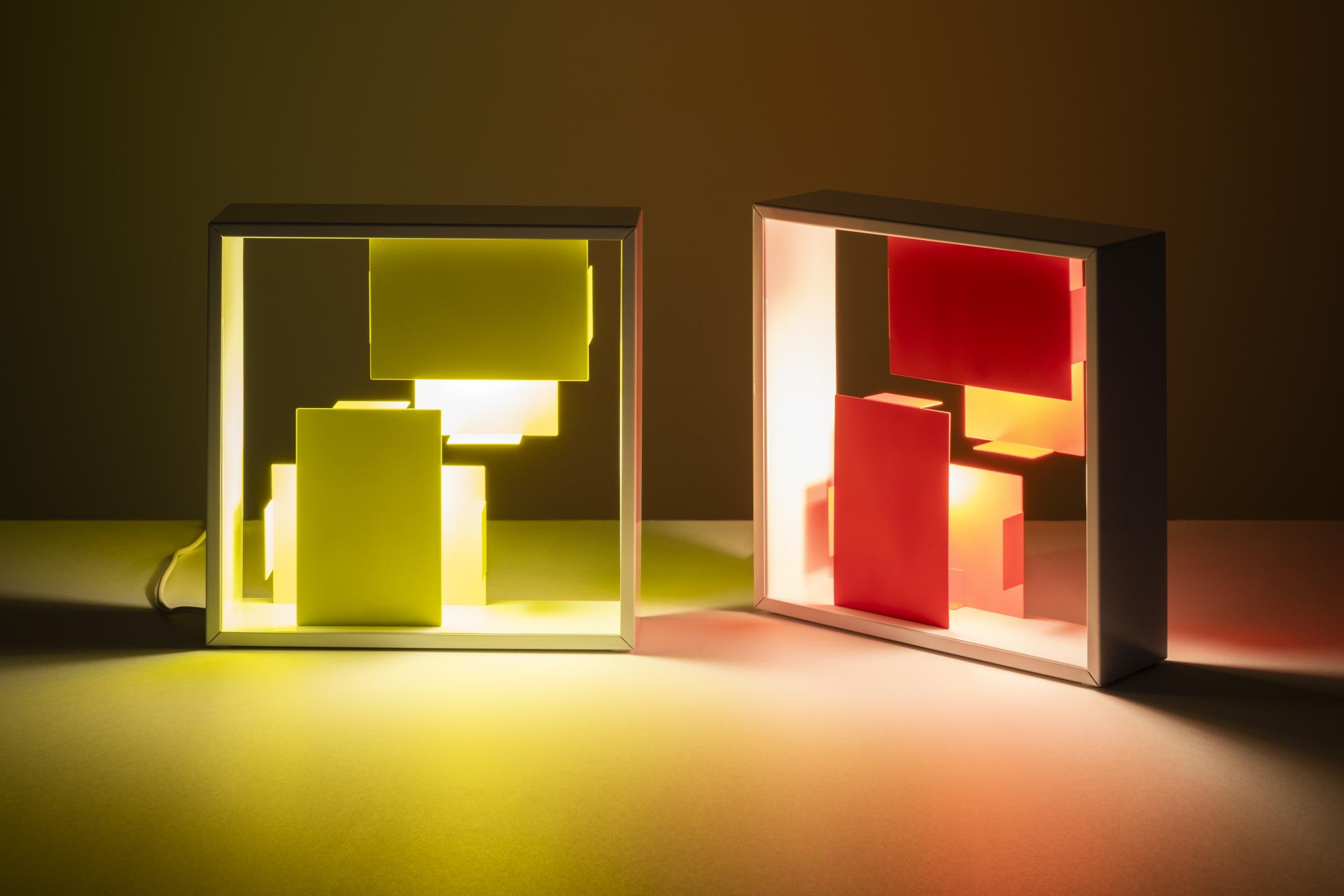 Bold bi-colour Tolomeo Micro lamps in vibrant yellow and red, showcasing Artemide's latest design innovation.