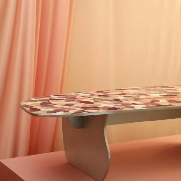 Artistic table with a colorful patterned surface, displayed at the Harewood Biennial 2022, showcasing social purpose.