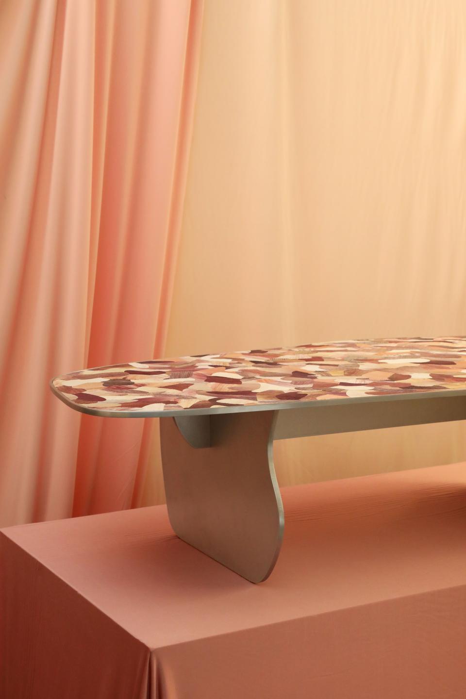 Artistic table with a colorful patterned surface, displayed at the Harewood Biennial 2022, showcasing social purpose.
