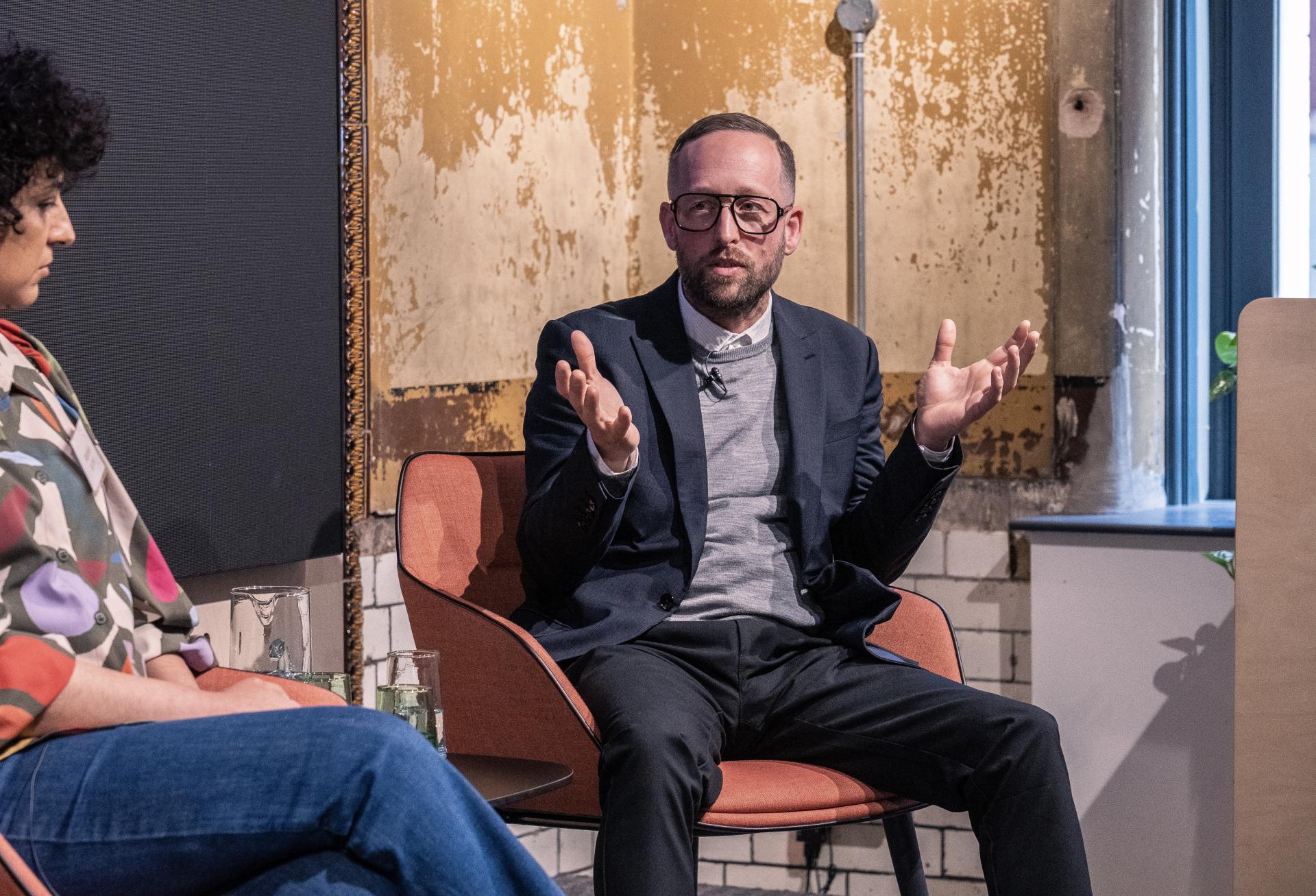 Panel discussion featuring a speaker engaged in a conversation about innovative technology at Material Source Studio event.