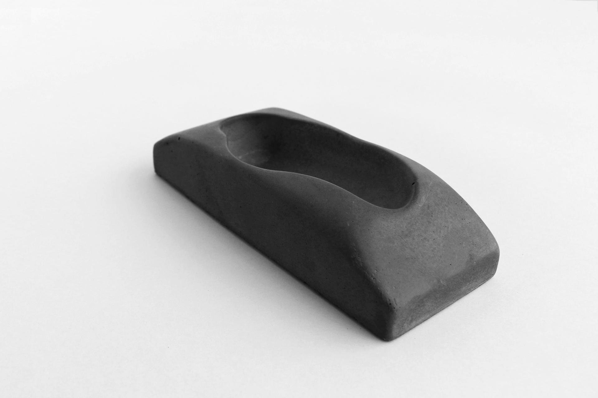 Sleek black ceramic piece by Jo Woffinden, showcasing modern design and craftsmanship at Harewood House Biennial.