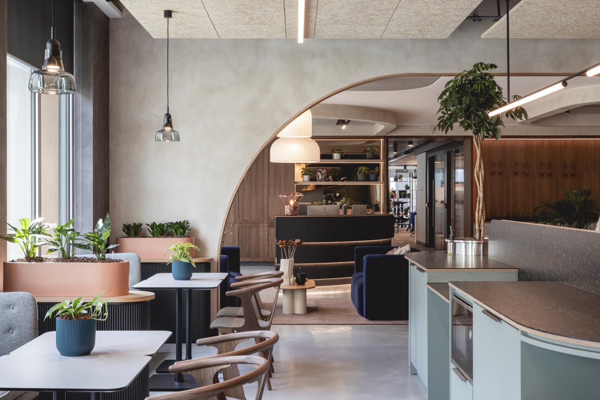 Modern workspace featuring Art Deco-inspired design, calming plants, and inviting seating for collaborative environments.