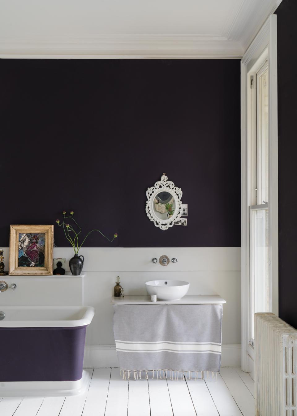 Elegant bathroom featuring Farrow & Ball's dark wall paint, a vintage mirror, and stylish fixtures.