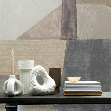 Stylish wallcovering from Omexo displayed in a home setting with decorative items on a table.