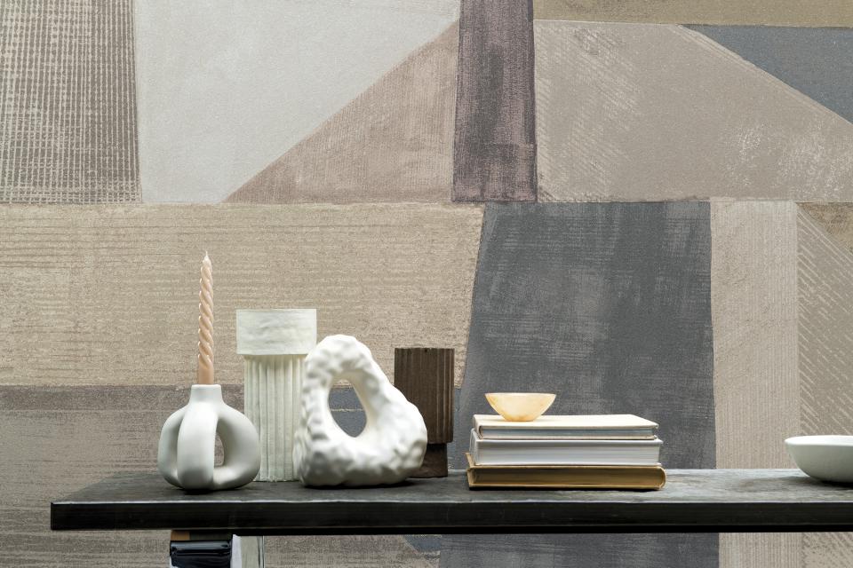 Stylish wallcovering from Omexo displayed in a home setting with decorative items on a table.