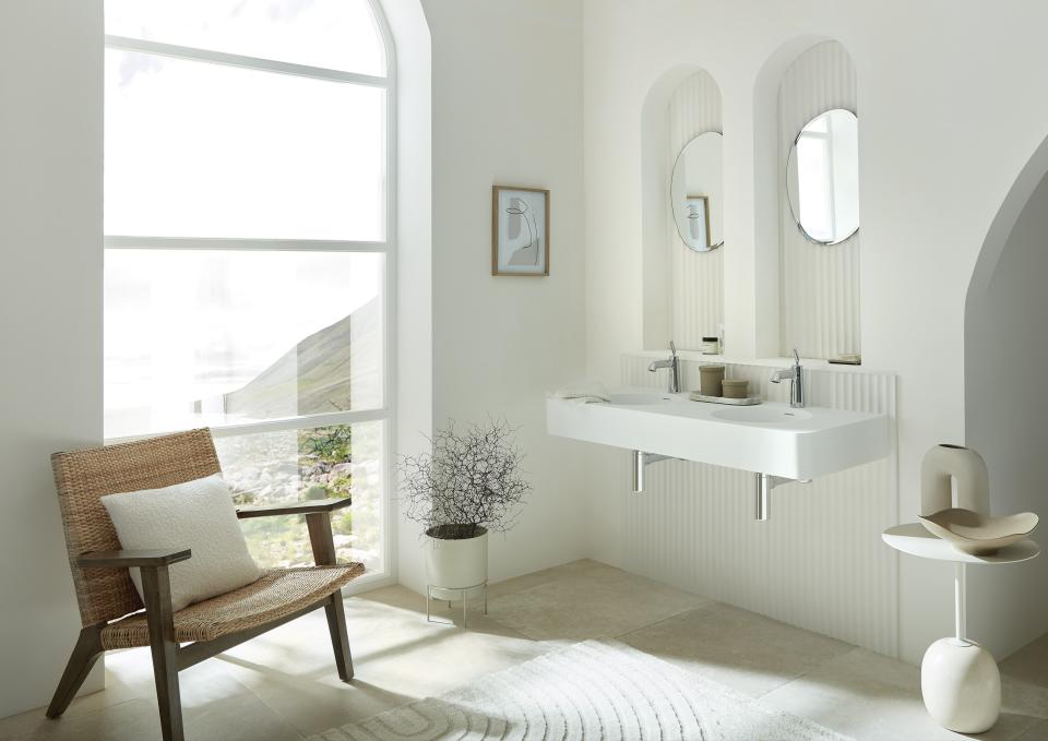 Modern bathroom featuring VADO’s Arrondi sink design by Conran and Partners, accentuated by natural light and minimalist decor.