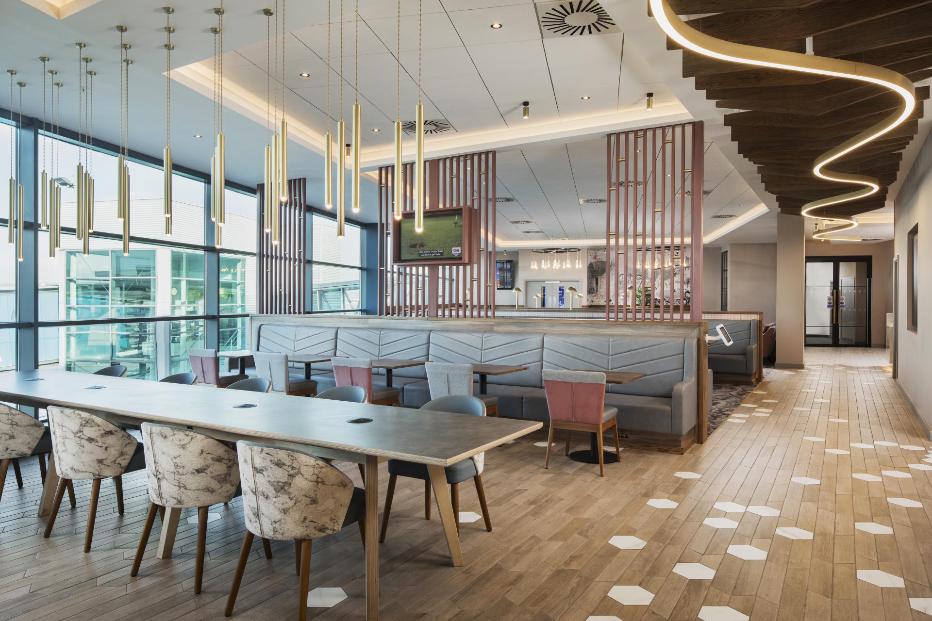 Modern aviation lounge interior with stylish decor, featuring comfortable seating and large windows, capturing the essence of airport design.