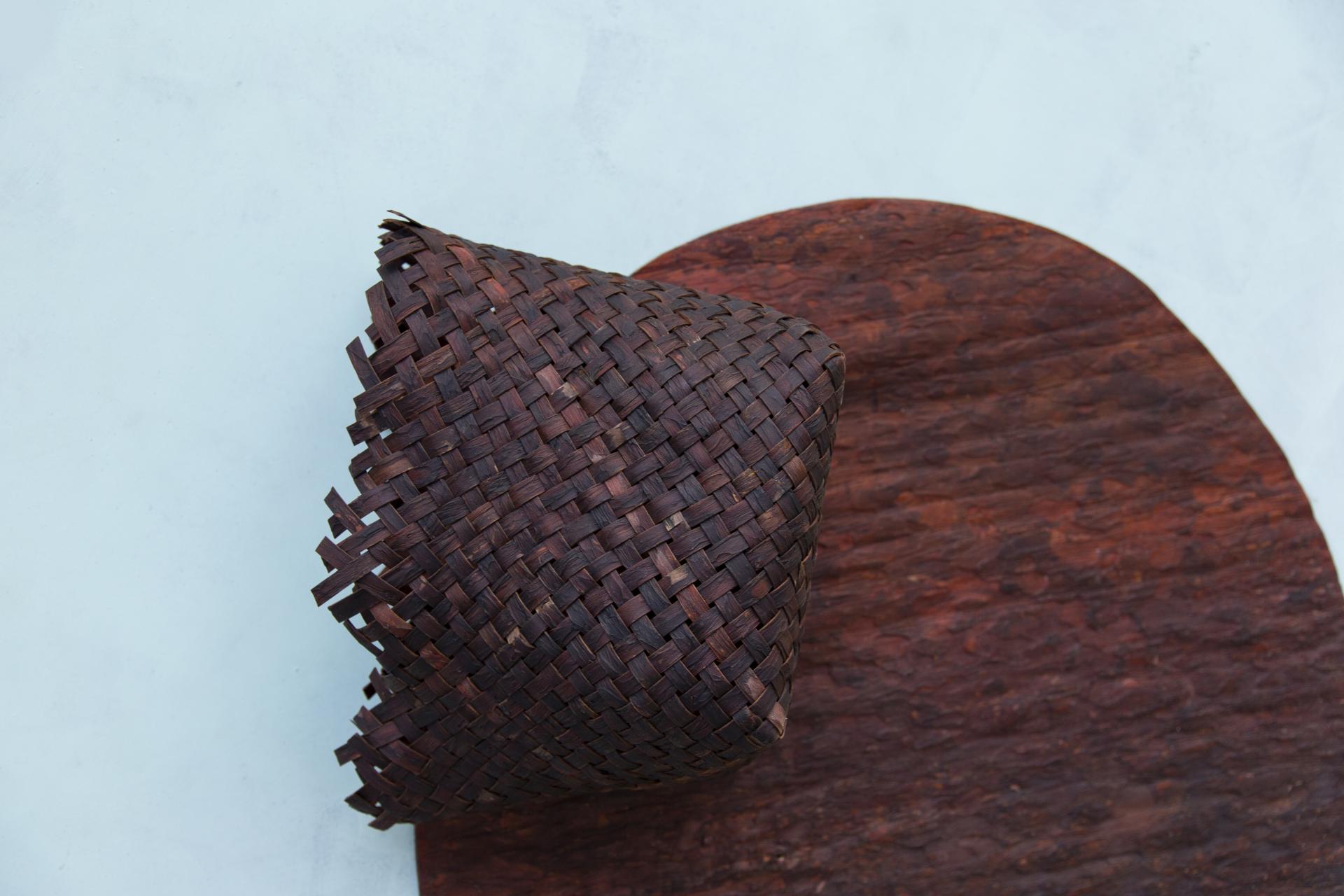 Woven biomaterial piece resting on textured design surface, showcasing Studio Sarmite's commitment to sustainable design practices.