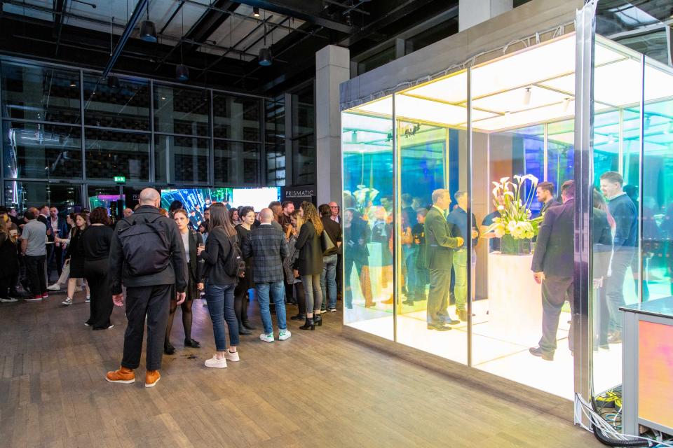 Lutron's Prismatic interactive experience engaging attendees in a vibrant event space filled with colorful lighting and design inspiration.