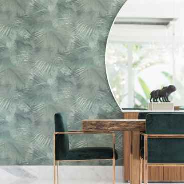 Elegant dining area featuring minimalistic design, green velvet chairs, and a textured botanical wallpaper backdrop.