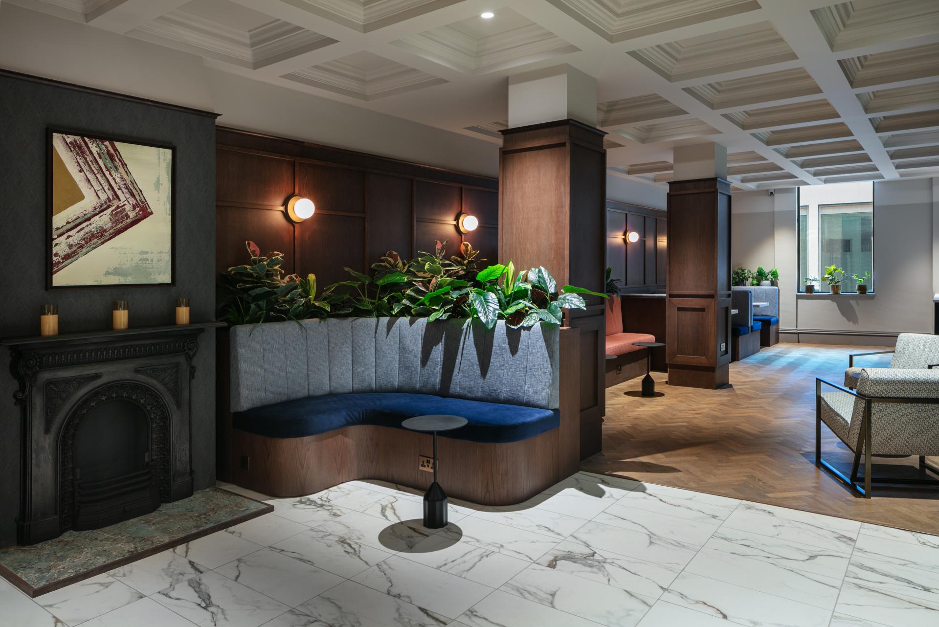 Stylish interior of a modern workspace featuring cozy seating, greenery, and elegant design elements for creative collaboration.