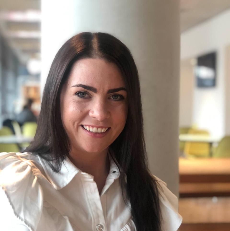 Rachel Bishop from BDP smiling in a modern office setting, emphasizing collaboration and core values in architecture.