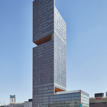 Modern architectural design of The Stratford showcasing its unique structure and integration within Stratford City, emphasizing hospitality and culture.