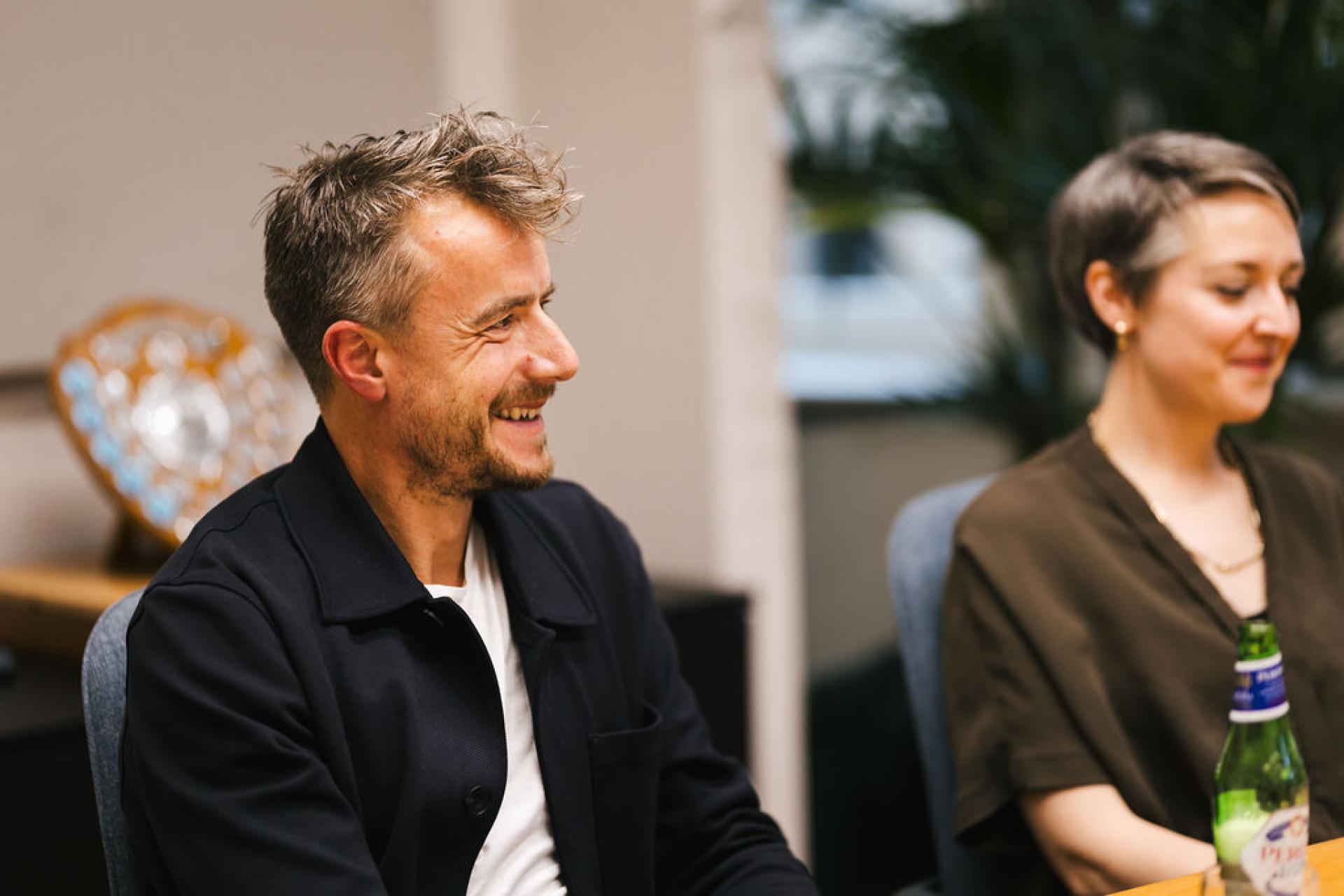 Discussion at Glasgow property seminar featuring two engaged attendees sharing insights on the local market outlook.