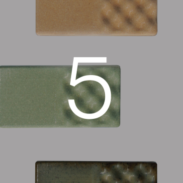 Textured clay tiles in earthy tones showcased in Atelier Barb's Bio Series collection, emphasizing sustainable design aesthetics.
