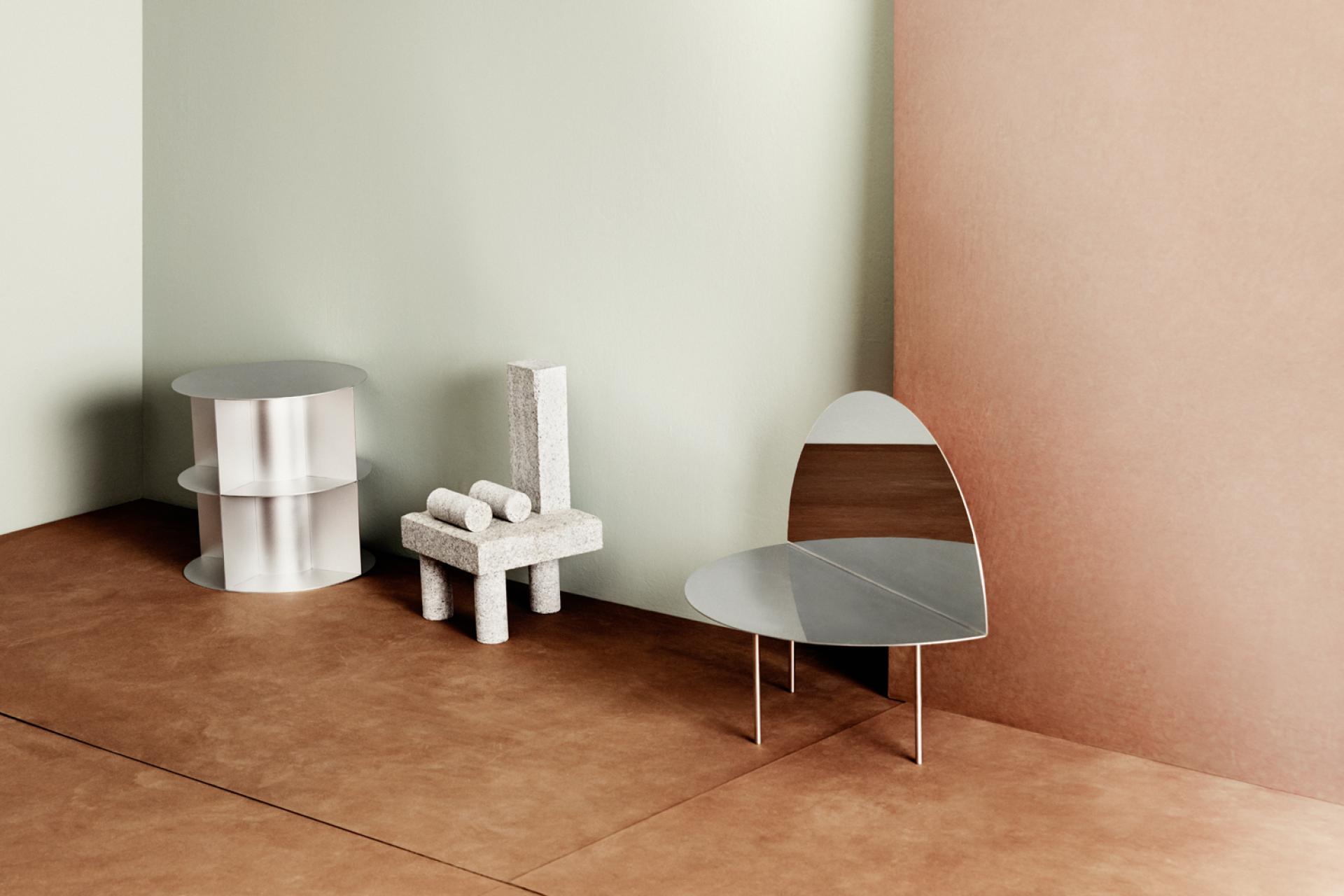 Modern furniture pieces showcasing sustainable design, including a mirrored chair and textured side tables, against a minimalist backdrop.