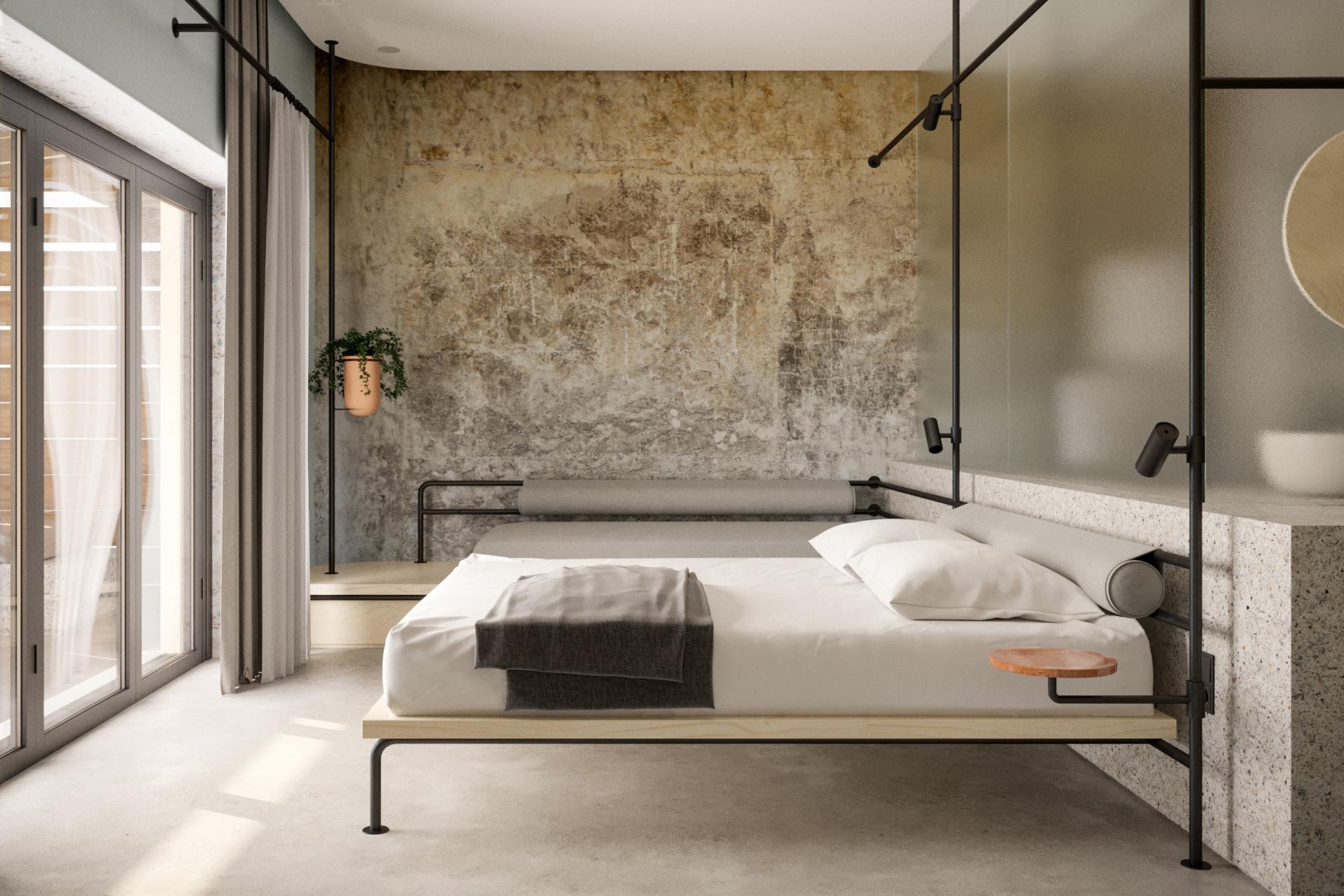 Stylish hotel bedroom in a concrete wine factory, featuring modern furnishings and a rustic textured wall.
