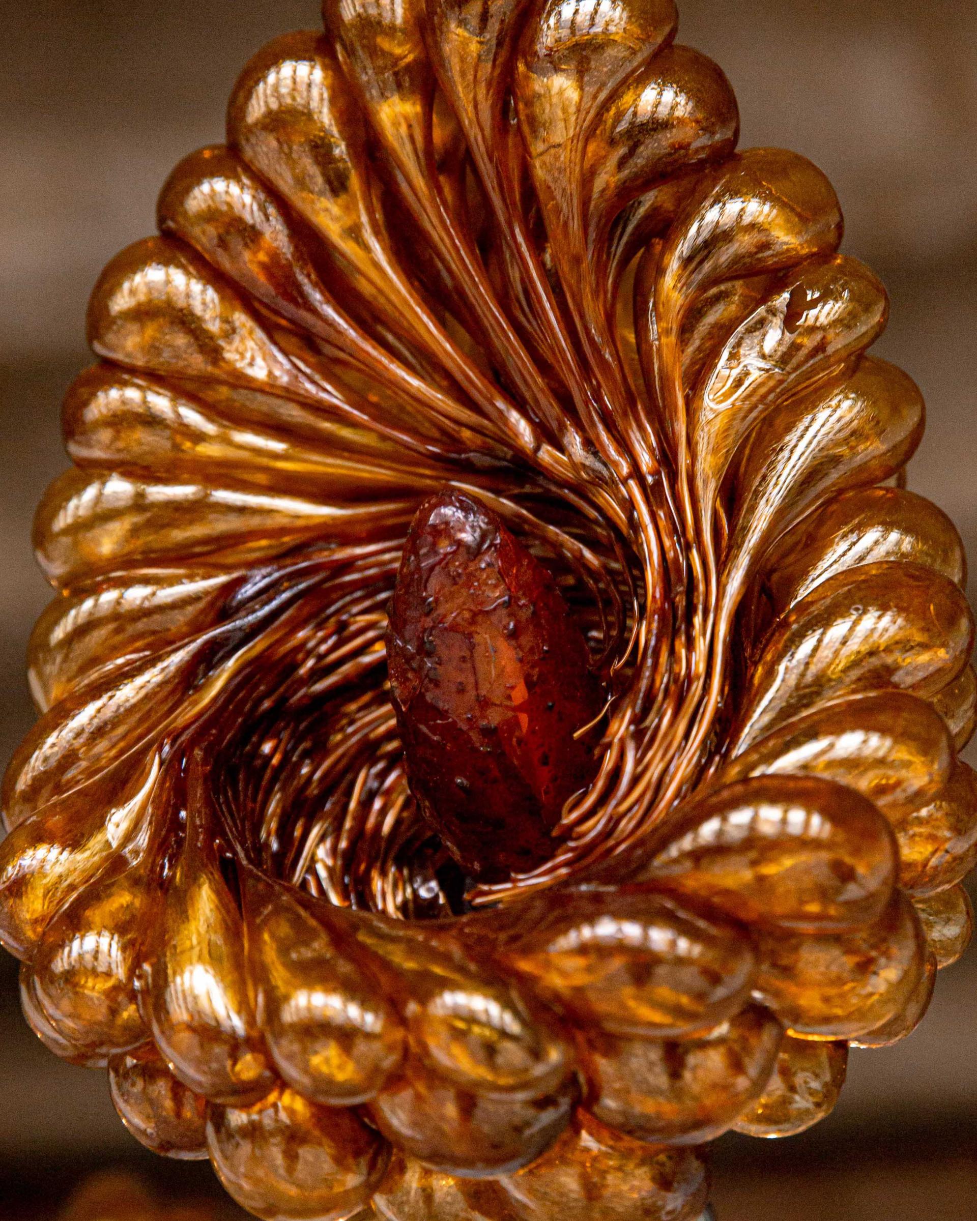 Intricate organic sculpture showcasing shimmering insect-derived lac, emphasizing natural textures and warm amber tones.