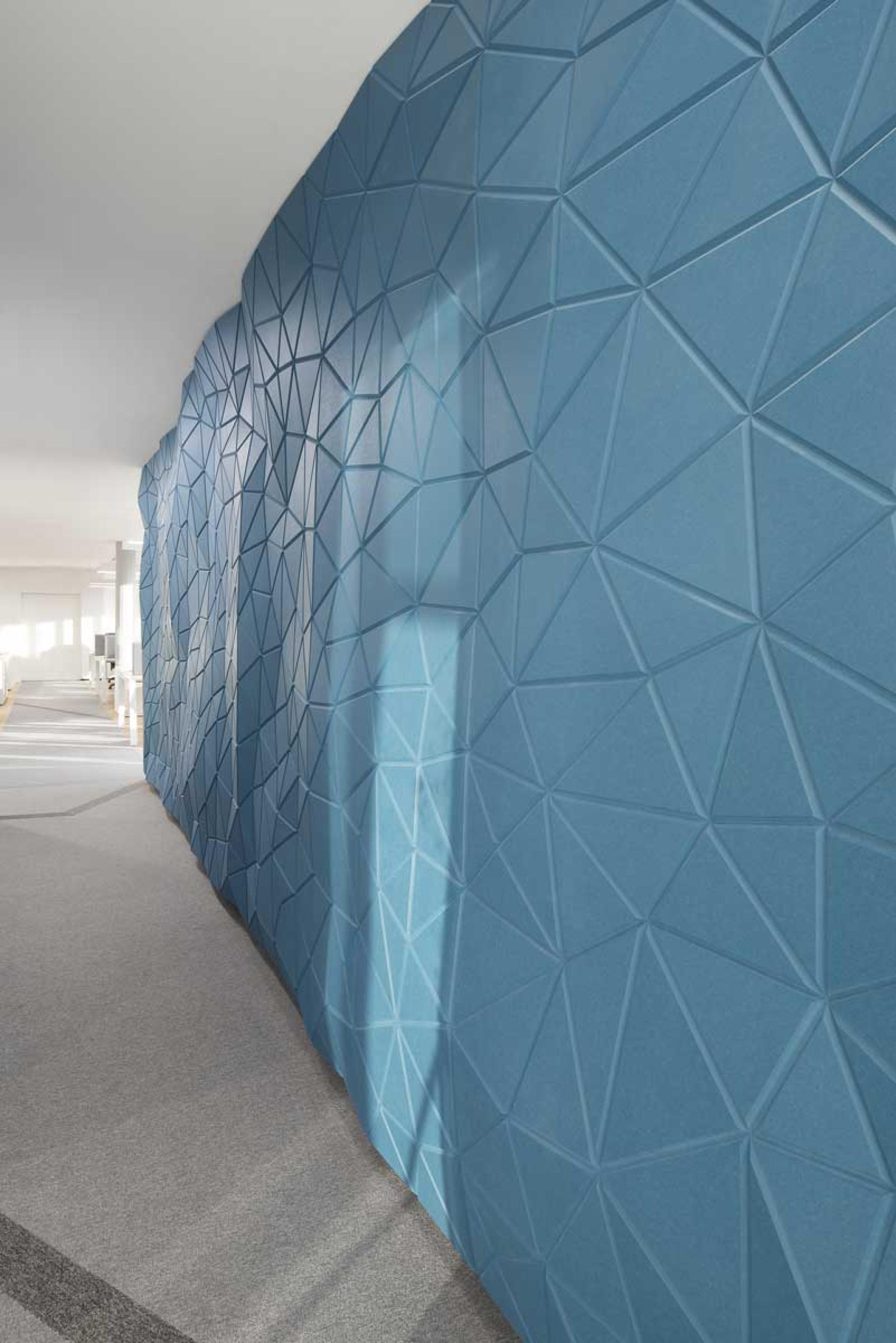 Textured blue wall with a modern geometric design, showcasing innovative architectural elements for Volkswagen Financial Services headquarters.