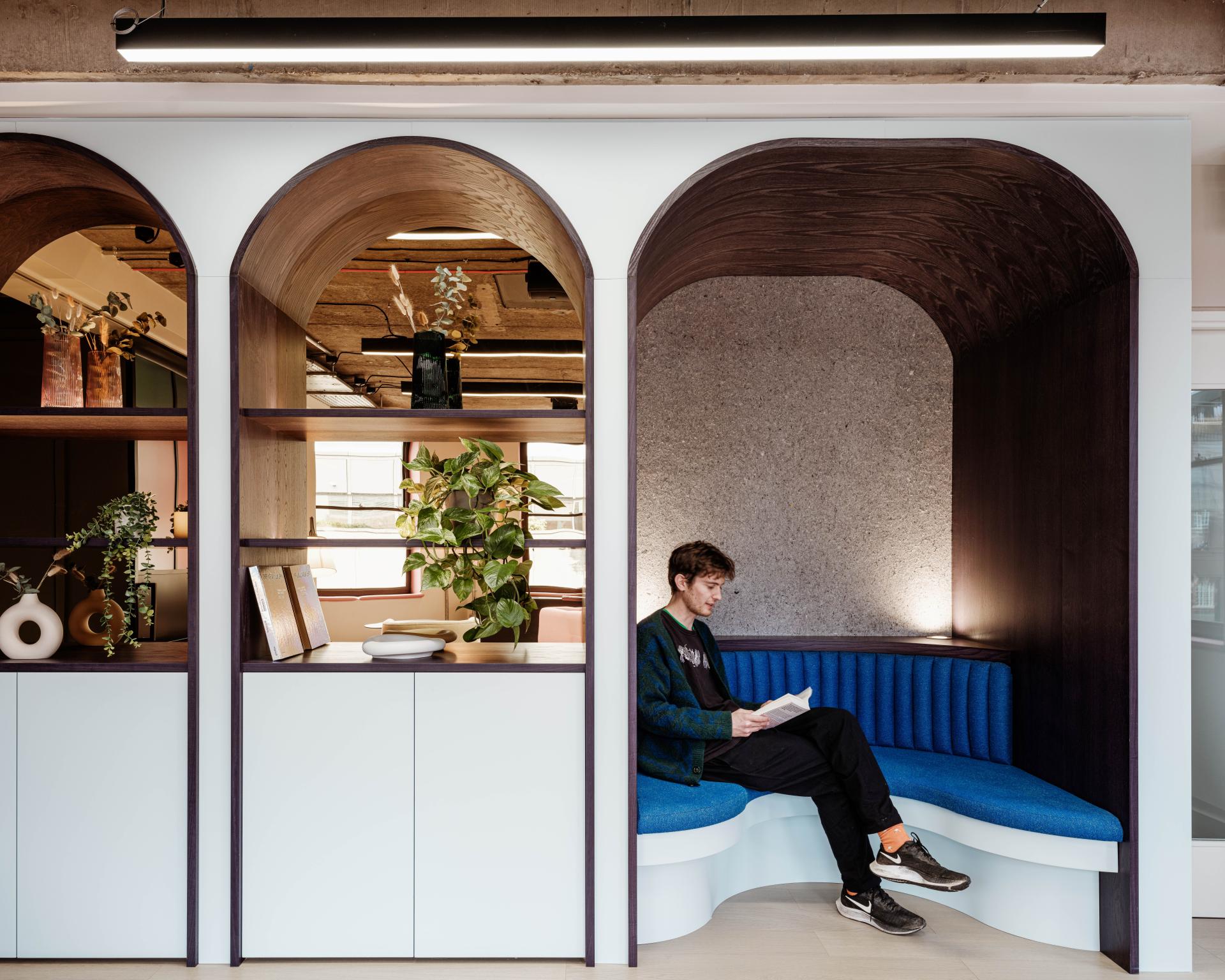 Modern co-working space at Huckletree Kensington featuring a comfortable nook, vibrant colors, and sustainable design elements.