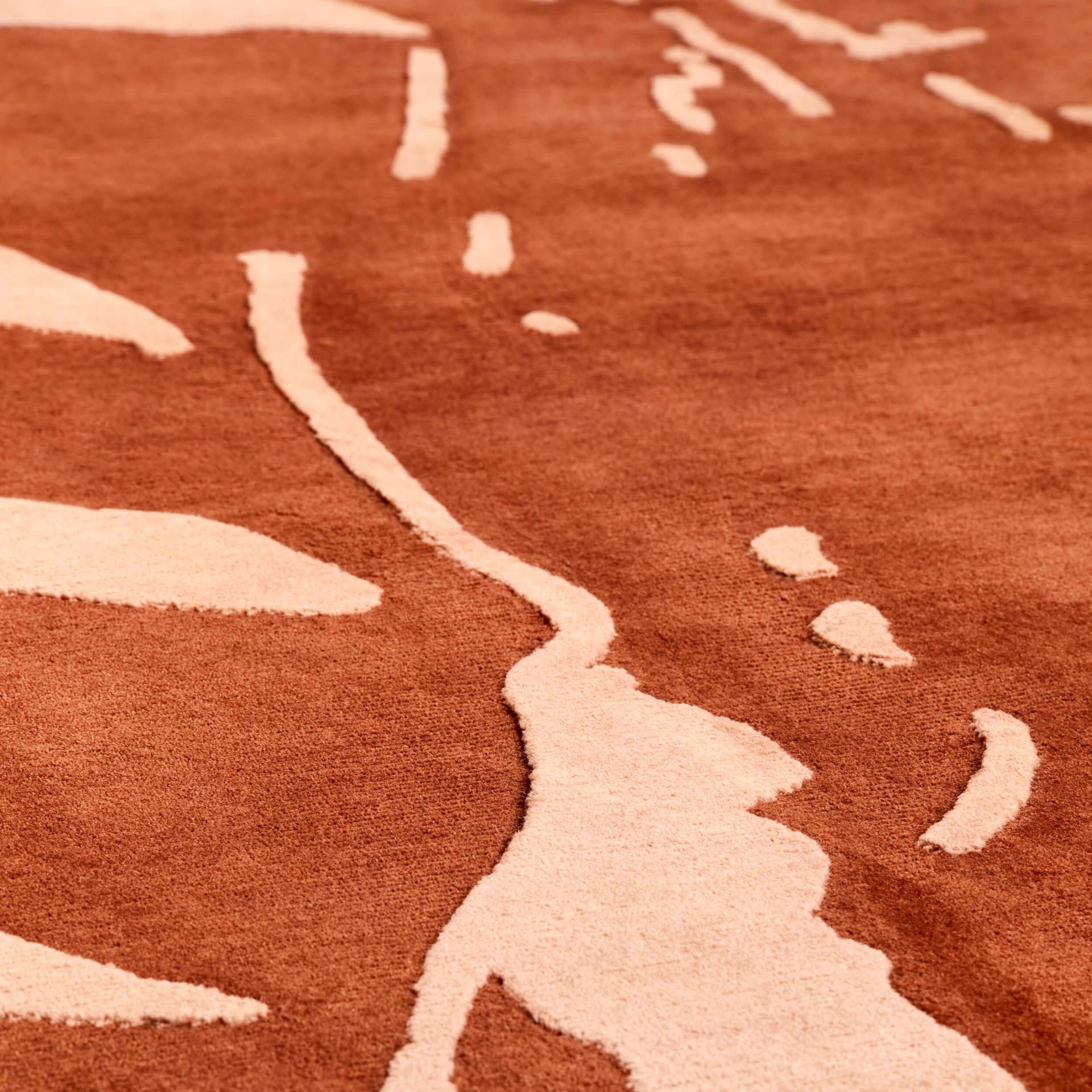 Textured brown and cream rug design, reflecting NoChintz's approach to storytelling and materiality in interior design.