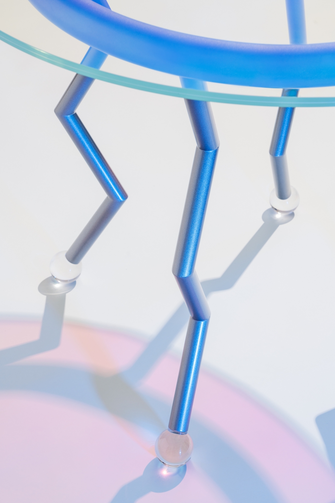 Medusa, Masanori Umeda, 2020 (based on a 1982 design), limited edition of 24 items + 1 artist's proof, “Night Tales” Collection, Post Design. Table with pale blue metal base, iridescent, dichroic glass top and round plexiglass feet. Dimensions: diameter 90, H 71.5 cm. Photograph © Delfino Sisto Legnani. Courtesy of Memphis srl.
