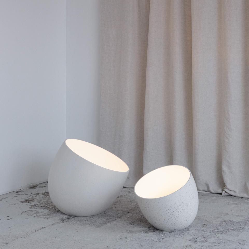 Modern designer lighting by Faïencerie de Charolles, featuring unique sculptural lamps in soft white tones.