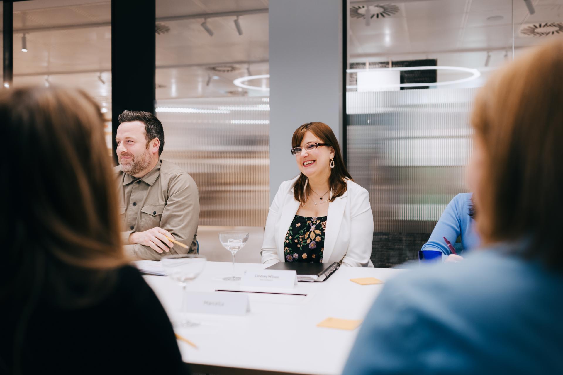 Participants engage in a roundtable discussion on neurodiversity at Material Source Studio, fostering flexibility in creative environments.