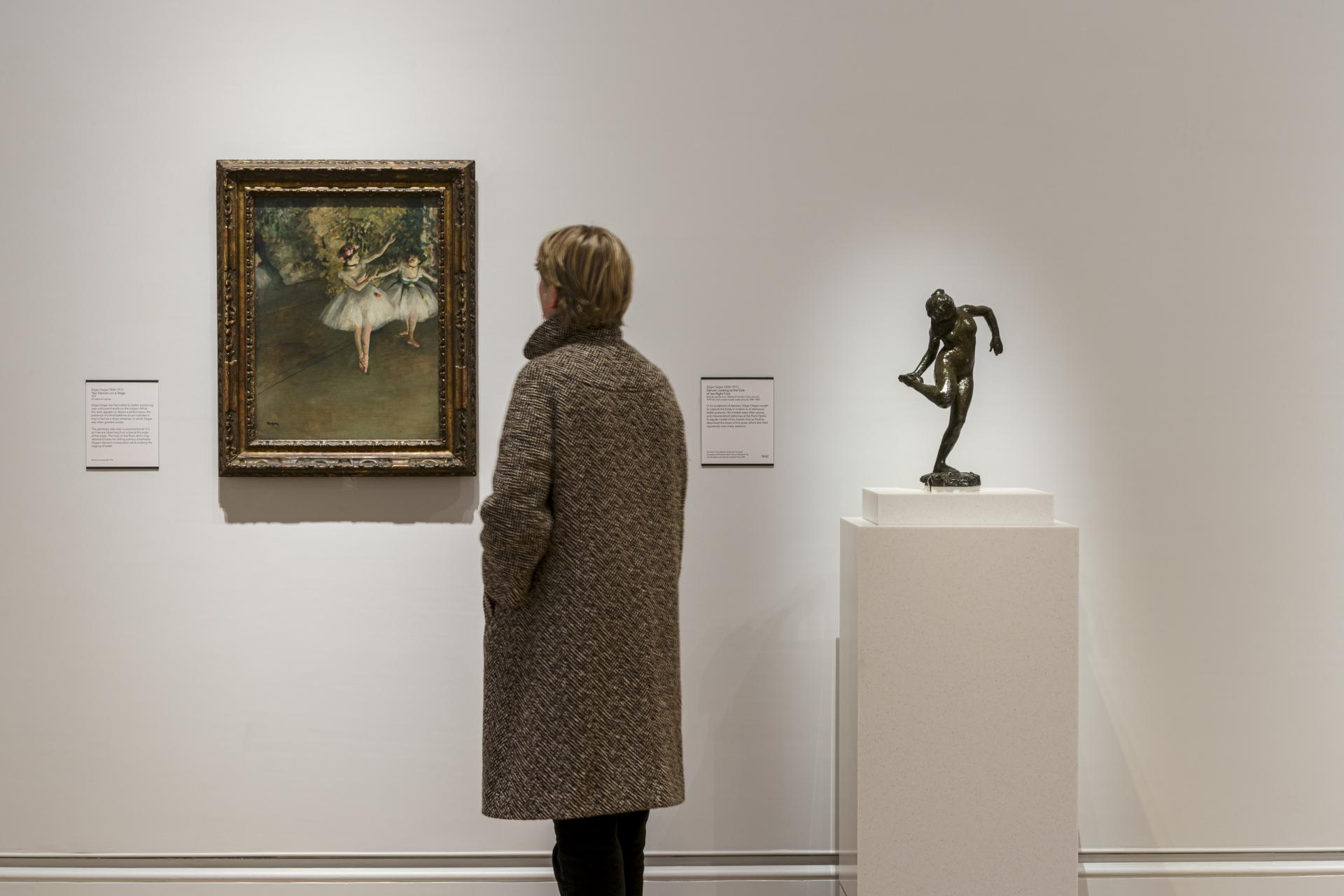 Visitor admiring a ballet painting and bronze sculpture at The Courtauld Gallery post-redevelopment, enhancing the art experience.