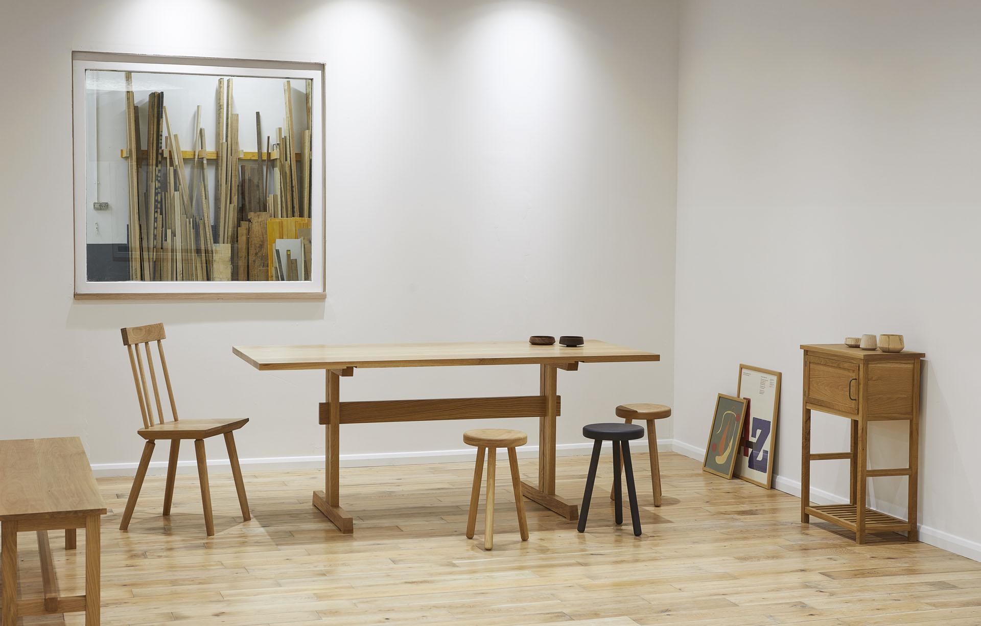 Stylish wooden furniture in a bright Glasgow studio, showcasing modern craft and design creativity in an artistic setting.