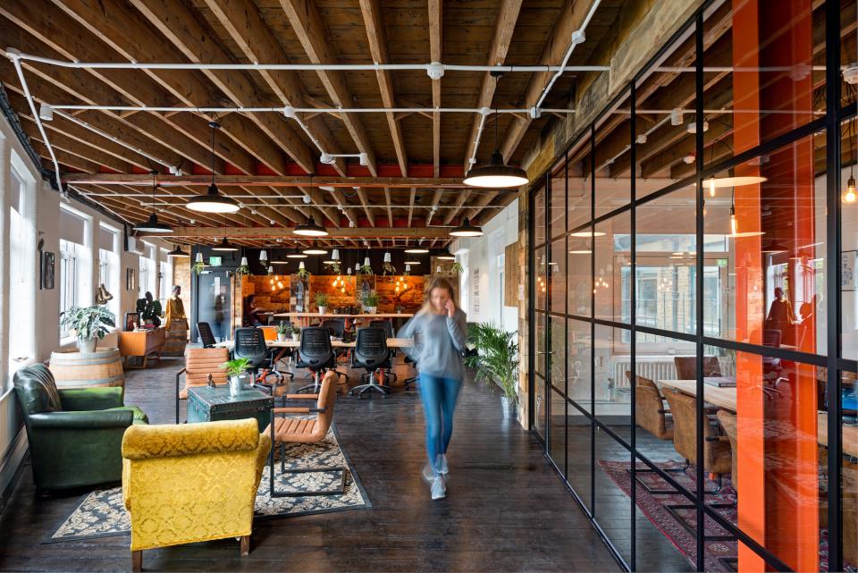 Redesigned industrial office space of Movember Foundation featuring unique seating, collaborative areas, and a bright, inviting atmosphere.