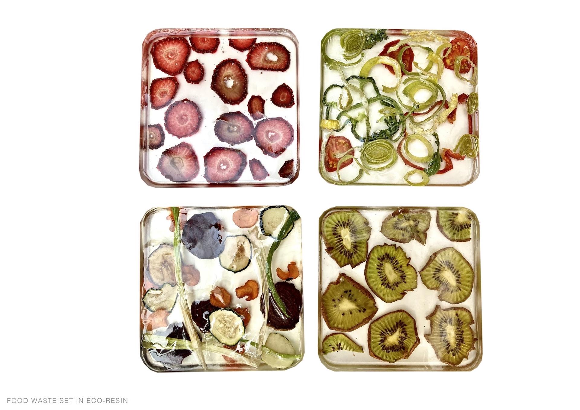 Colorful eco-resin food waste set showcasing dried fruits and vegetables, highlighting sustainable design in interior decor.