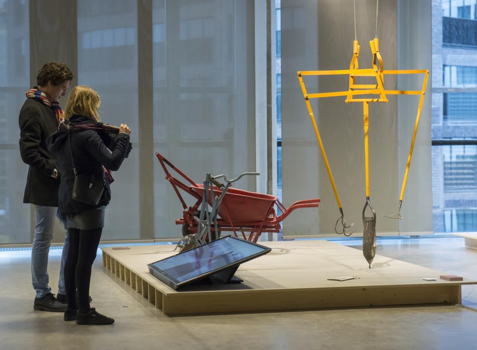 Visitors explore innovative design exhibits at Dutch Design Week, showcasing tools and concepts for a sustainable future.