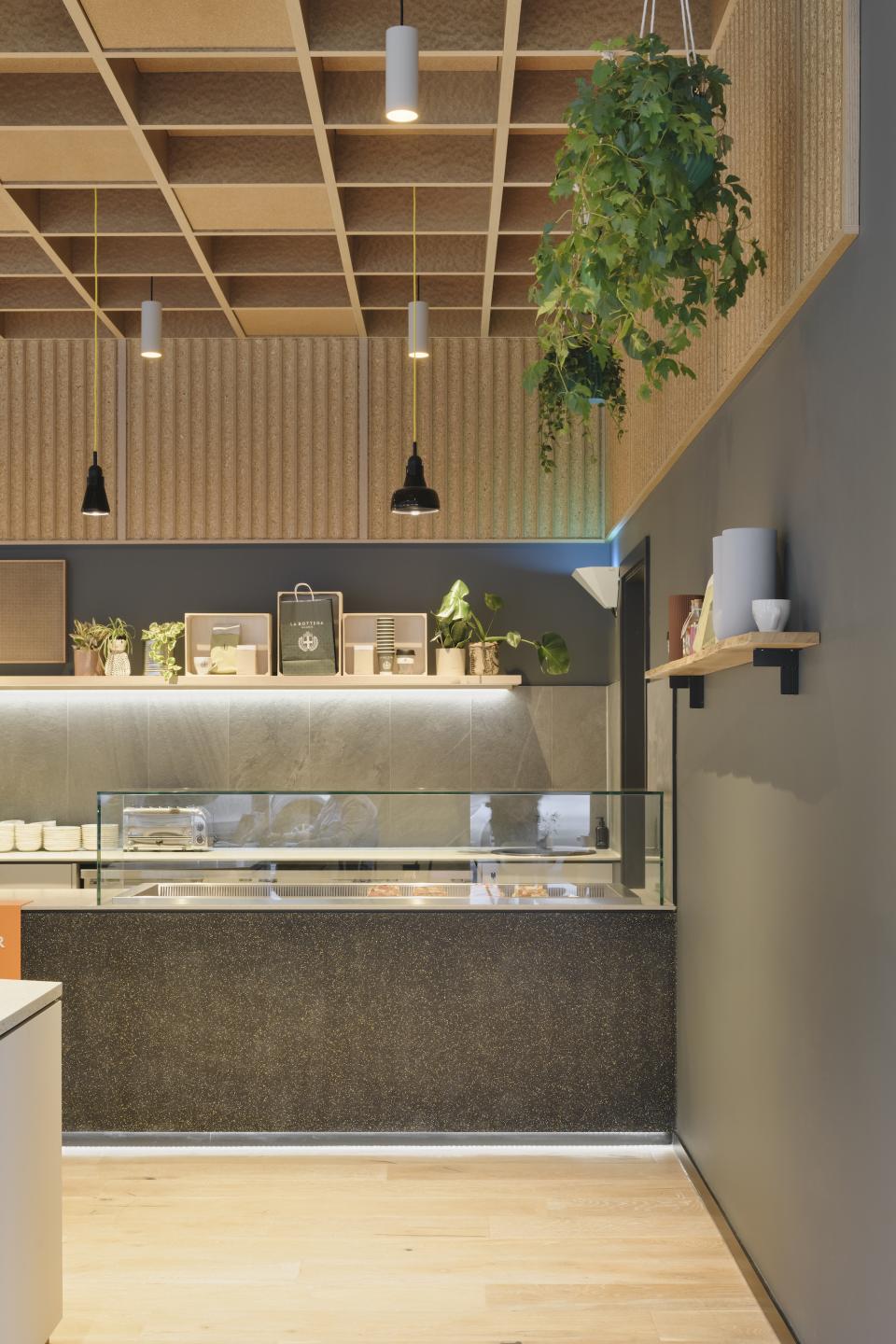 Modern interior design at Globe Point, Leeds, showcasing a stylish amenity space with lush greenery and contemporary lighting.