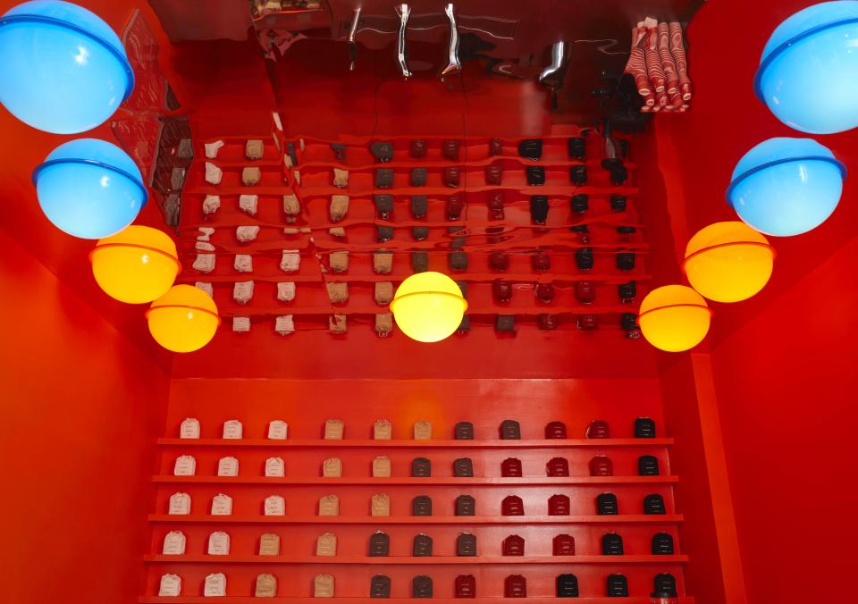 Vibrant interior of Café Nuances featuring psychedelic decor, colorful pendant lights, and stylish shelving design.