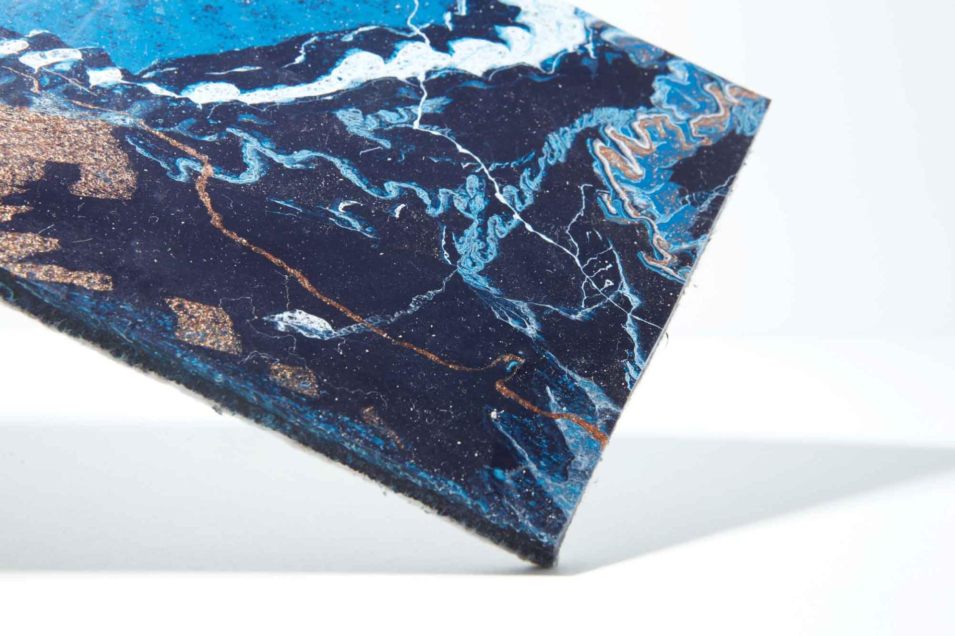 Colorful, textured surface design showcasing blue and black patterns, featured at the Surface Design Show 2019.