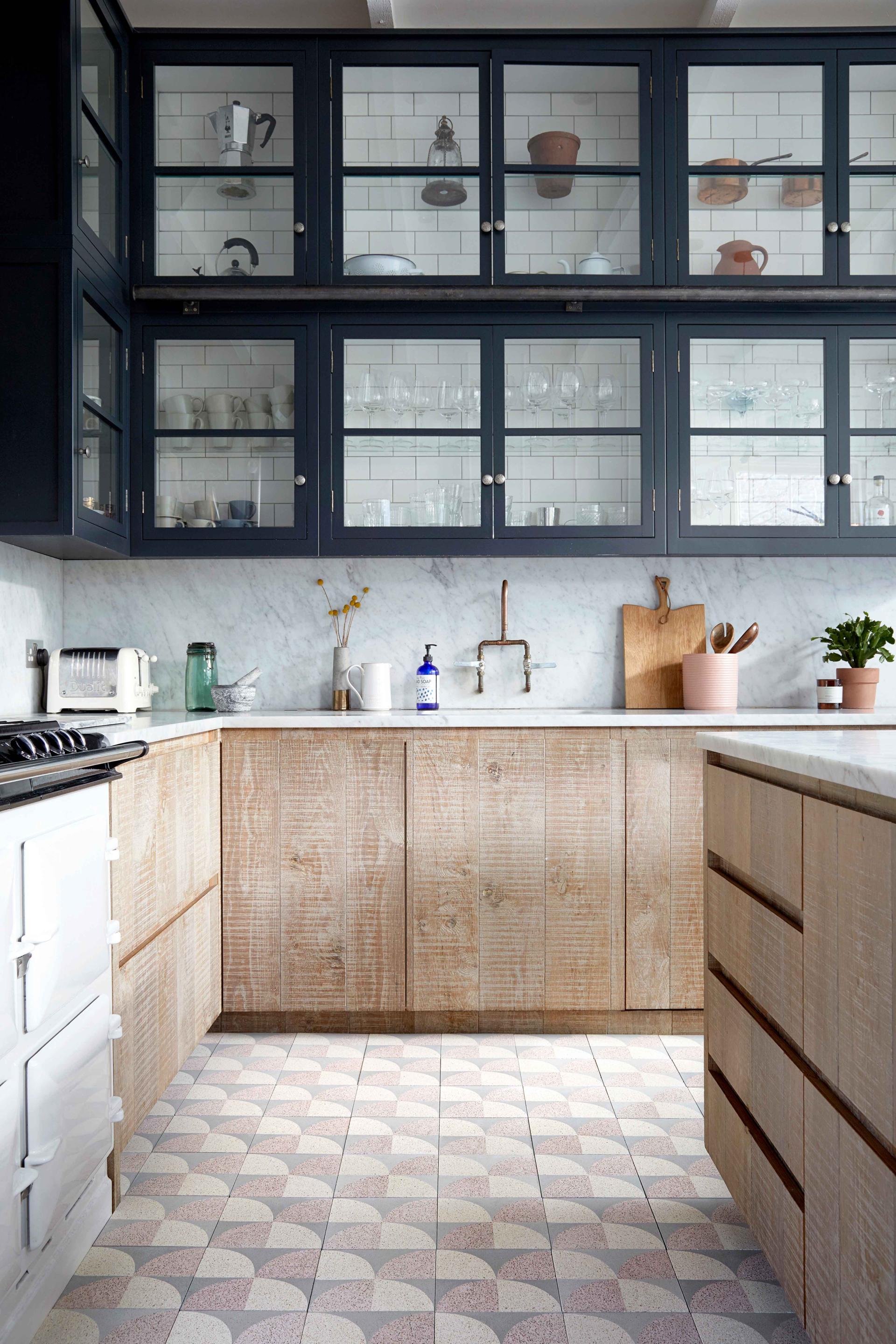 Stylish kitchen featuring Bermondsey patterned tiles by Lindsey Lang, wooden cabinetry, and modern kitchen appliances.