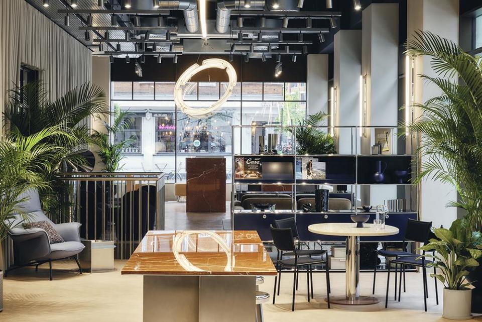Modern workspace at Brock House featuring stylish lighting, contemporary furniture, and lush greenery, enhancing the office ambiance.